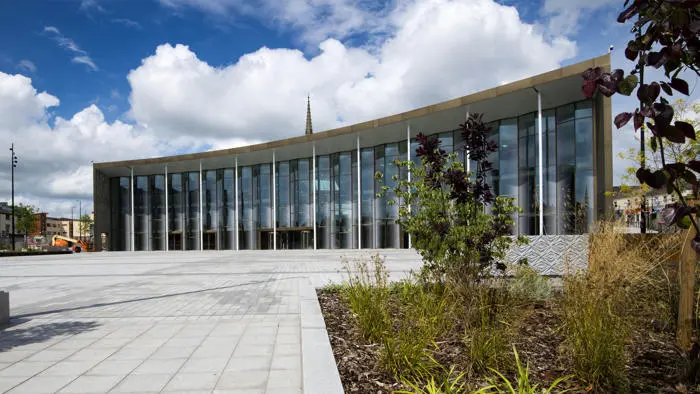 A picture of the student centre in the background with plants and flowers in the front