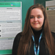 jessica geddes at a poster presentation smiling