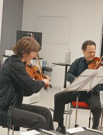 Musicians Elena Artamonova with viola and Yuri Kalnits with violin at the Border Crossings conference 