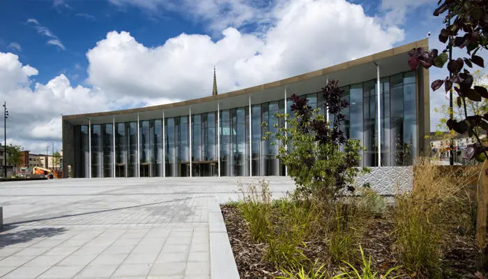 A picture of the student centre in the background with plants and flowers in the front