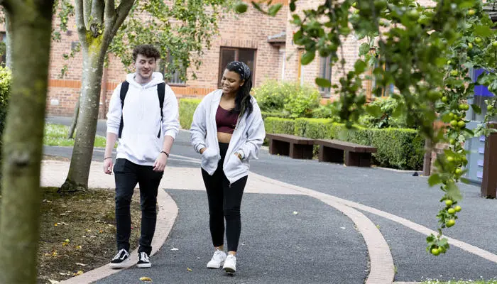 Two students walking on campus