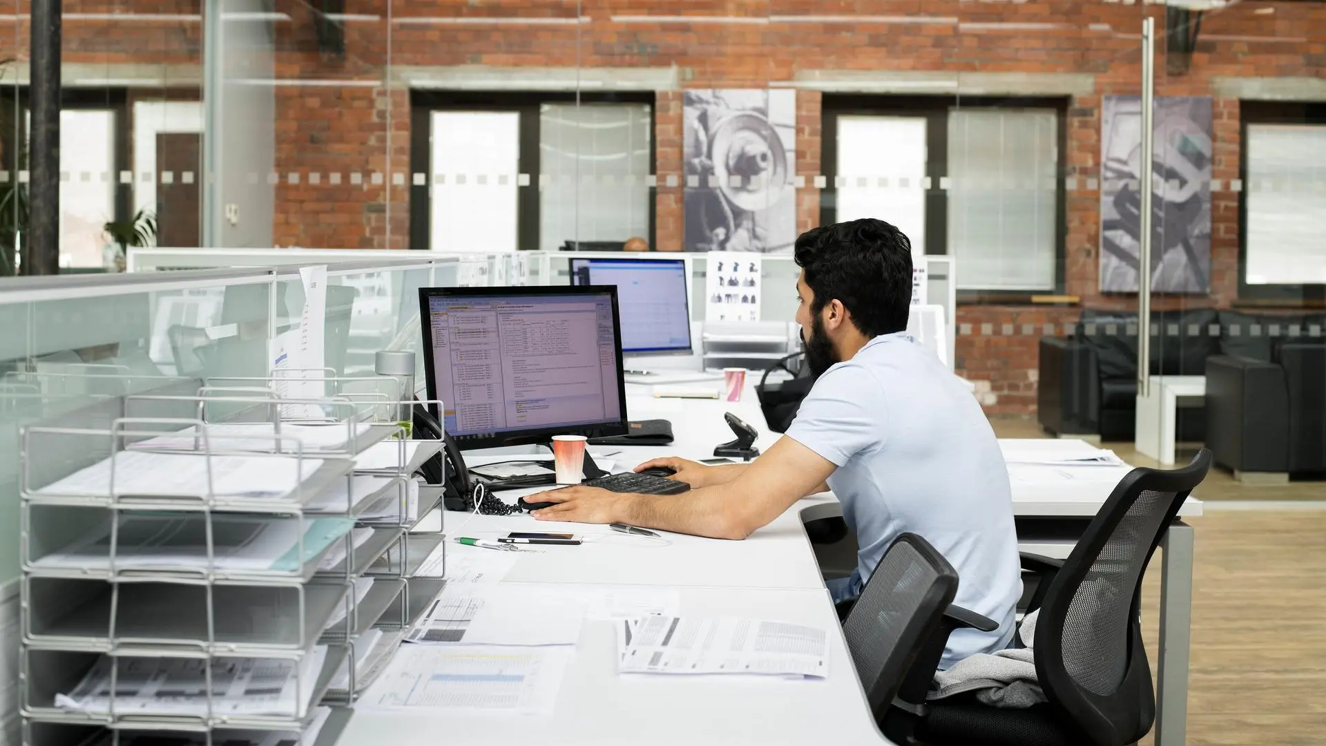 A person works on a computer in a modern office.