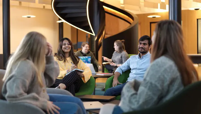 group of students sat chatting in the student centre