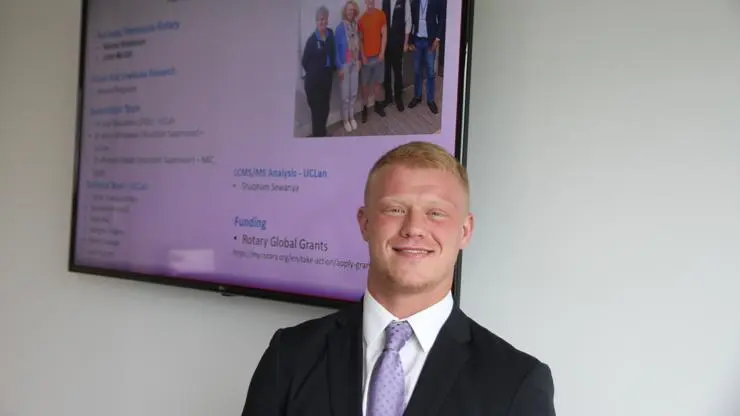 Jack Robinson standing next to his presentation