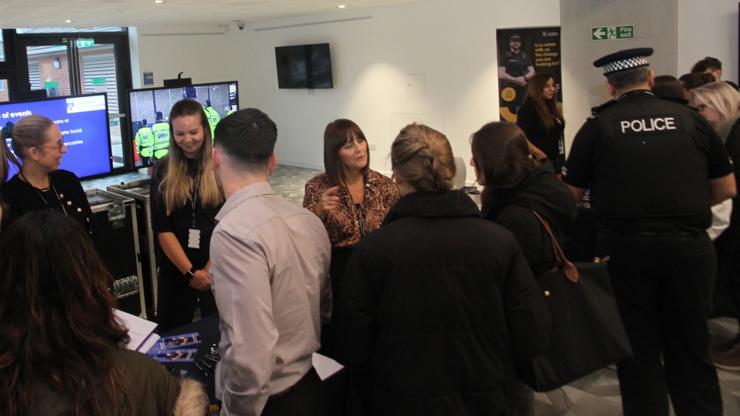 A crowd of event attendees and staff members