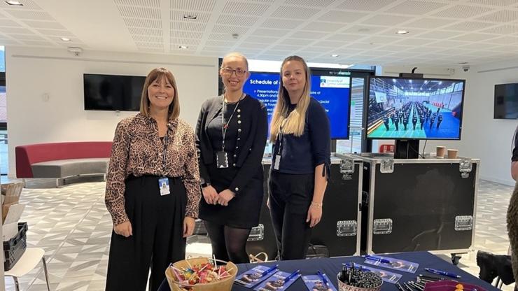 Staff members behind a Police recruitment stand