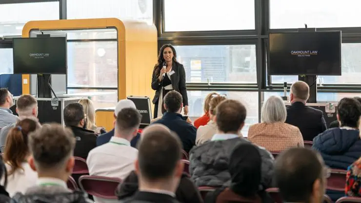 Tahera Khan speaks to a crowd of SPARK event attendees.