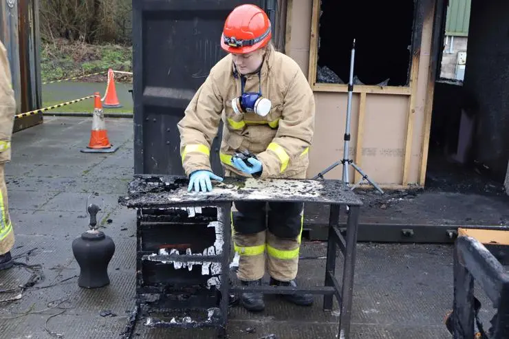 A student working on a fire investigation scene