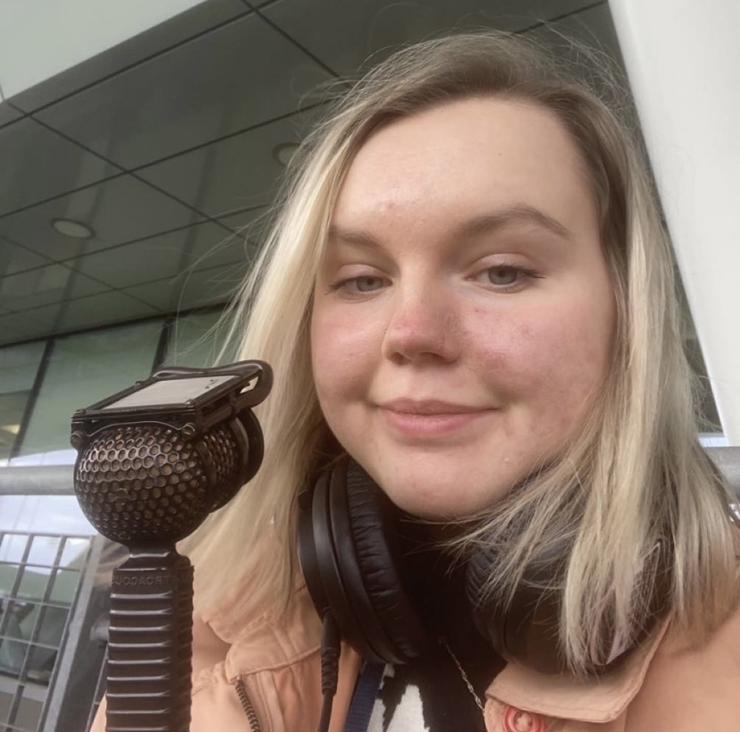 Holly commentating with a lip microphone