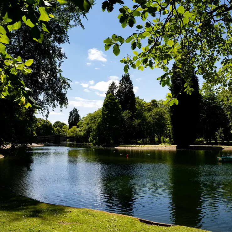 The boating lake in Thompson Park makes a serene spot for a picnic.