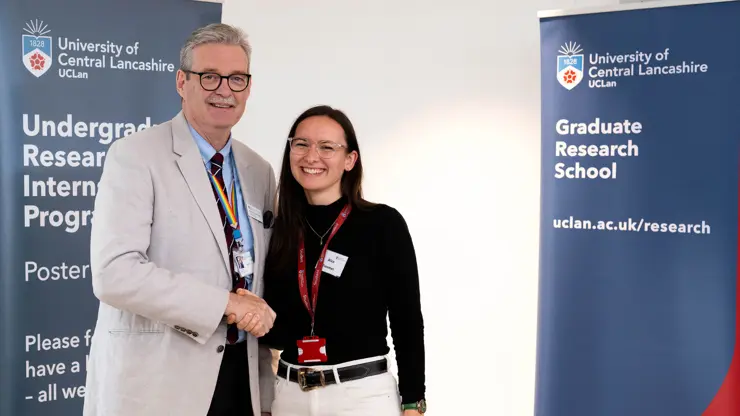 Professor StJohn Crean presenting Alice Freeman with an award. 