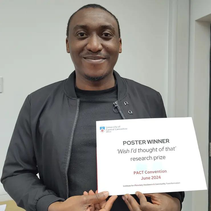 Arinze Uzoezie with his poster prize certificate