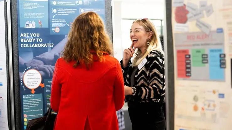 Katie Cairns talking to an event attendee