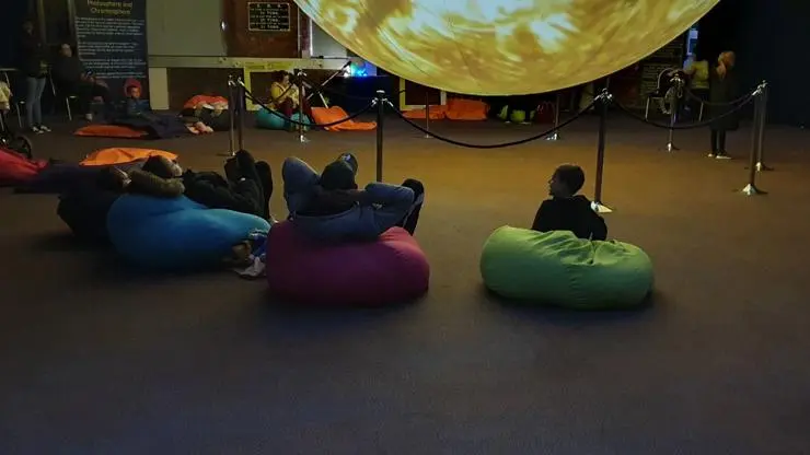 Visitors on beanbags basking in SUNlight at the Festival of Tomorrow, Swindon, 2023"