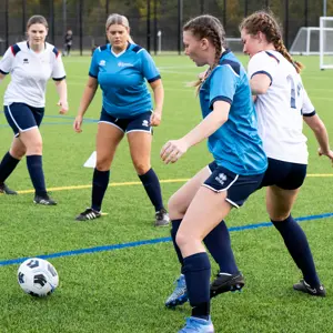 Students playing womens football match