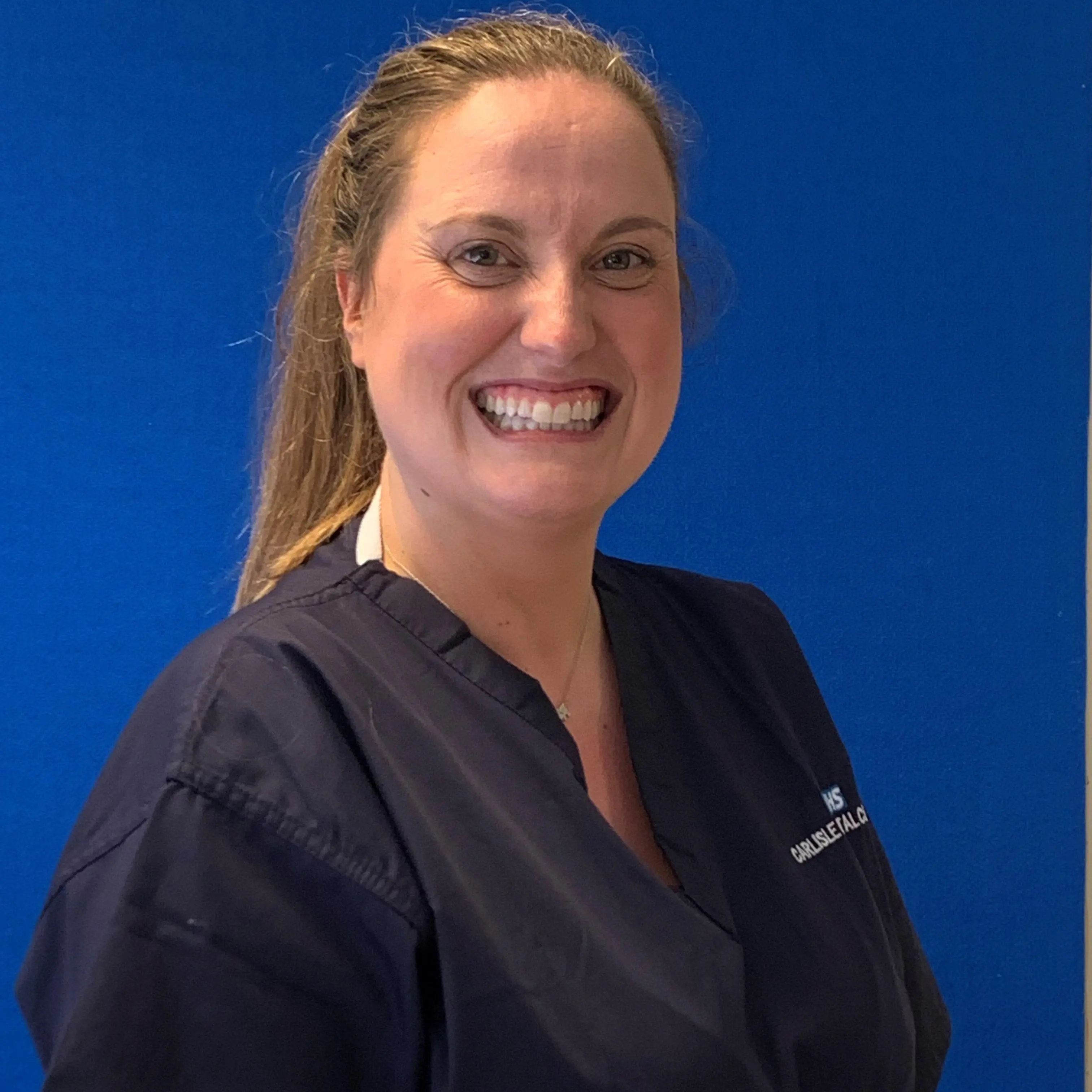 Jenny Durkin smiling in scrubs