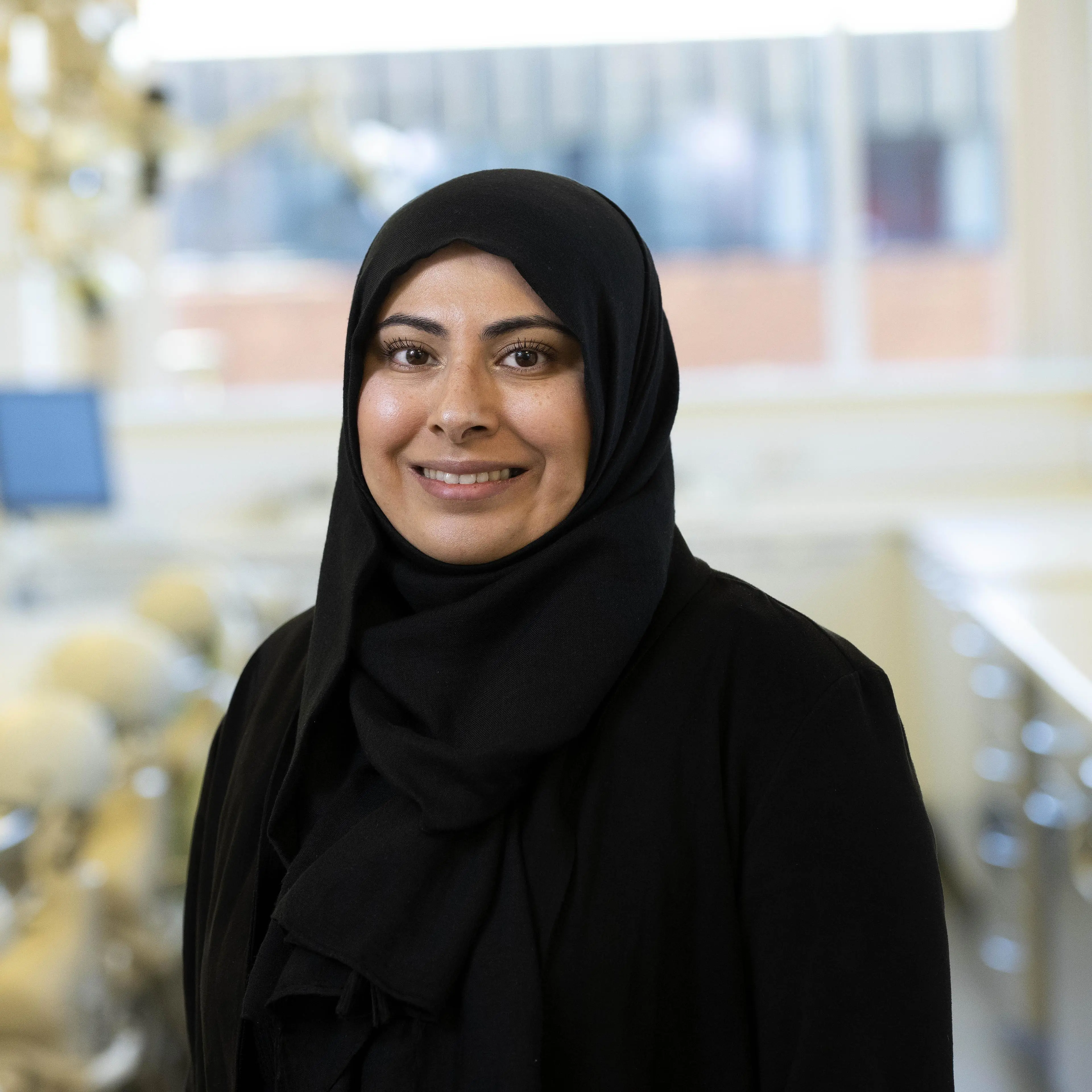 Nadia Shah in a black hijab smiling