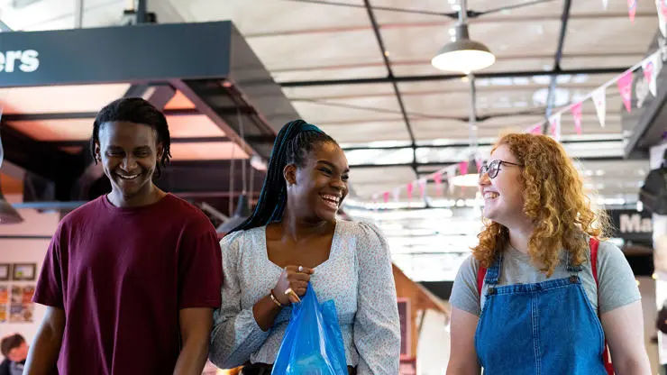 Students shopping in Preston Market Hall.