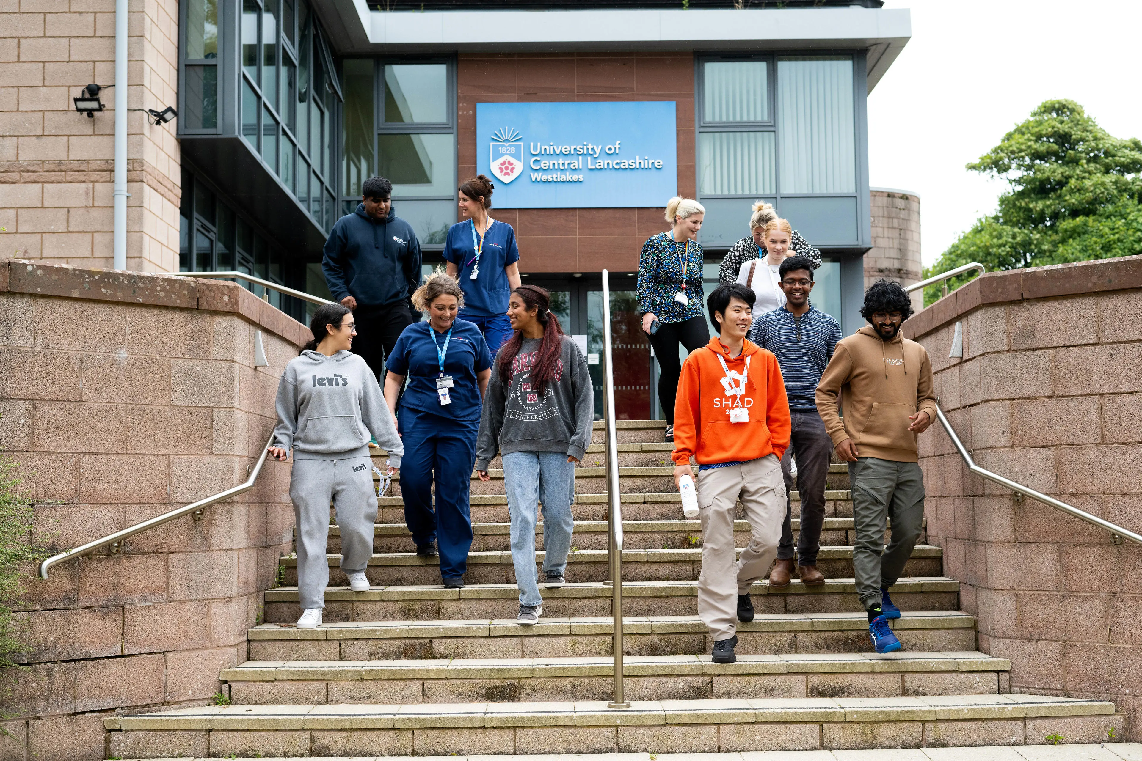 Students and tutors chatting and walking outside.