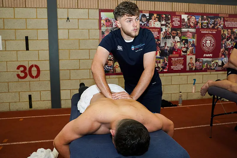 Sports Therapy Students Jake Durnell treats Jai Field from Wigan Warriors