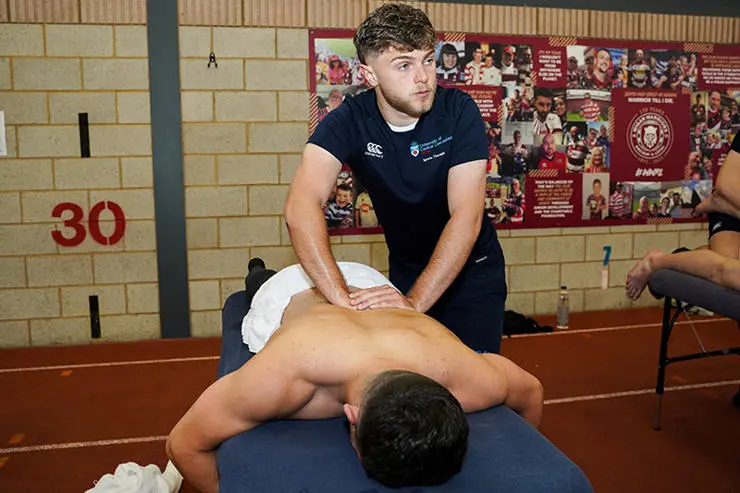 Student Jake Dunnell treats Warriors player Tom Forber