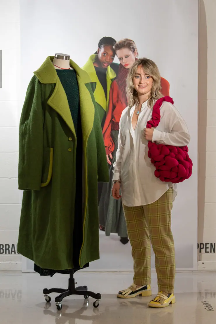 Phoebe with her long green coat and dress